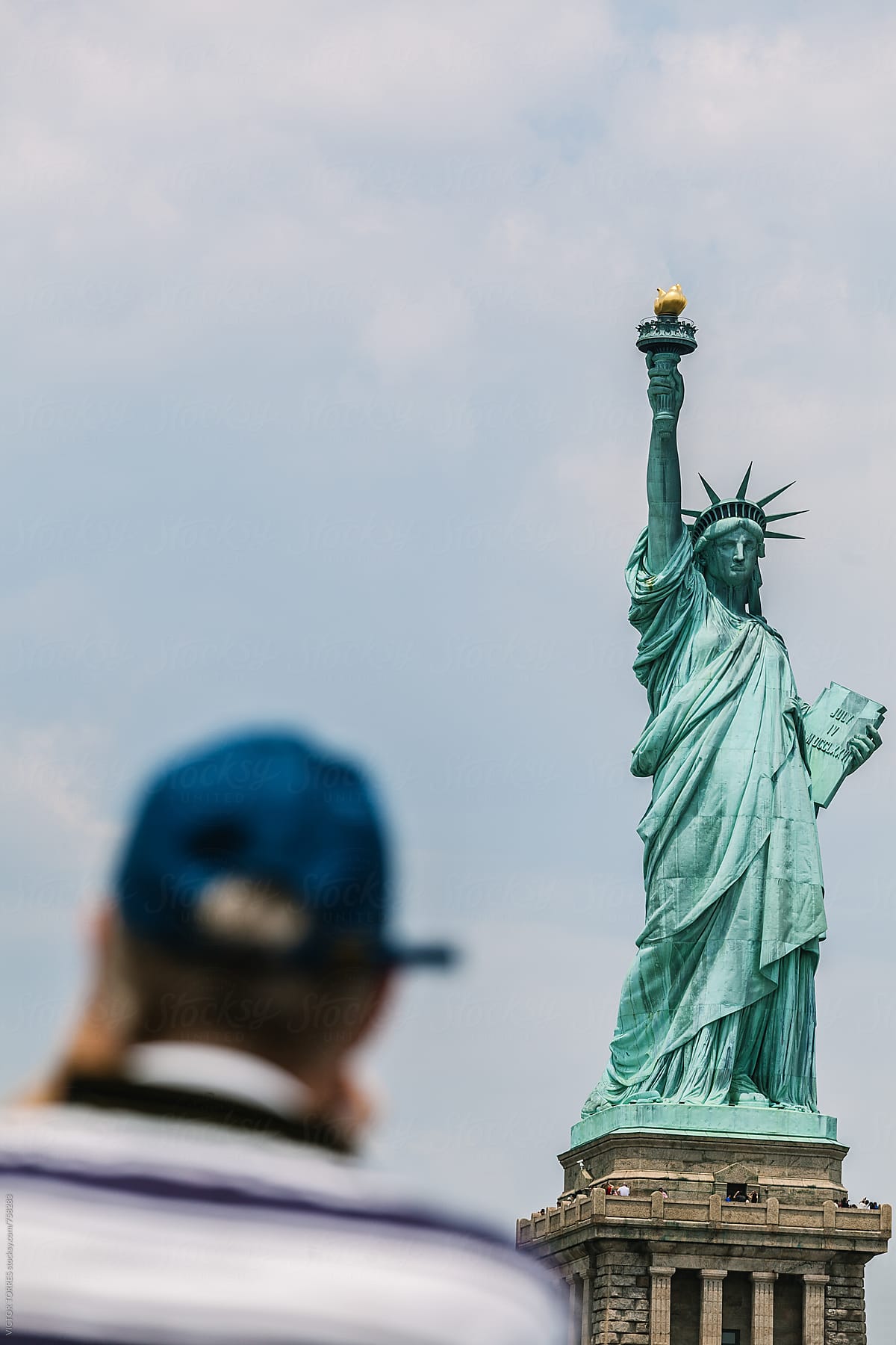 Tourist Taking a Photo to the Liberty Statue in New York