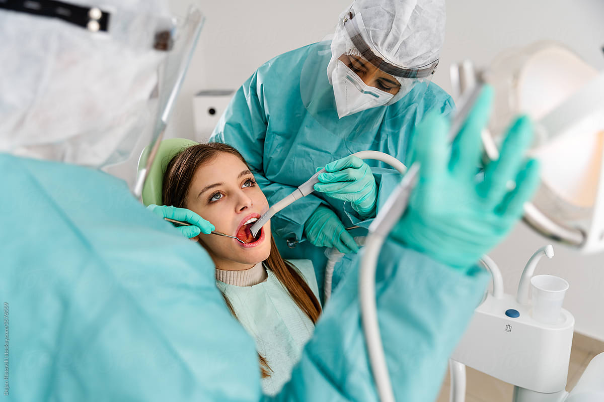 Dentist and assistant working on a patient in dentist clinic