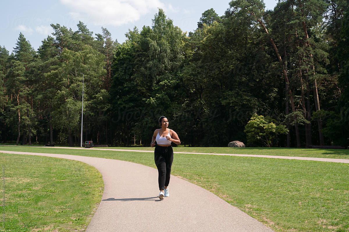 Plus Size Woman Running In The Park