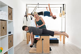 Woman performing Pilates exercise using a Cadillac or Trapeze table Stock  Photo - Alamy