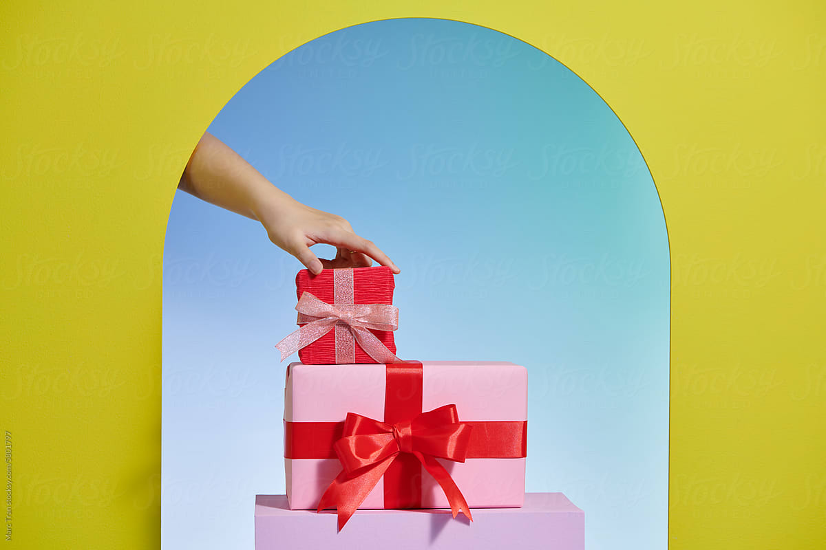 Hand taking a gift box on blue background