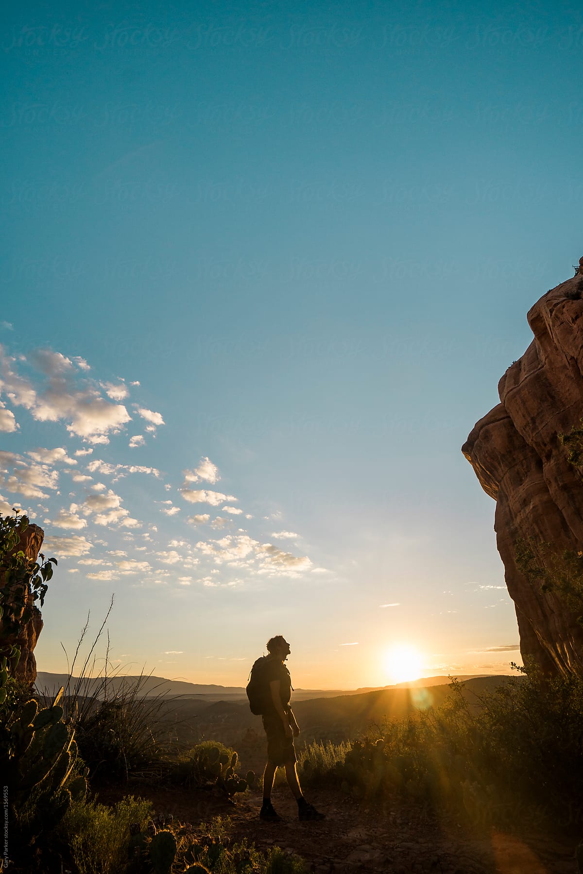 A young man watching the sunset Cathedral Rock, Sedona.