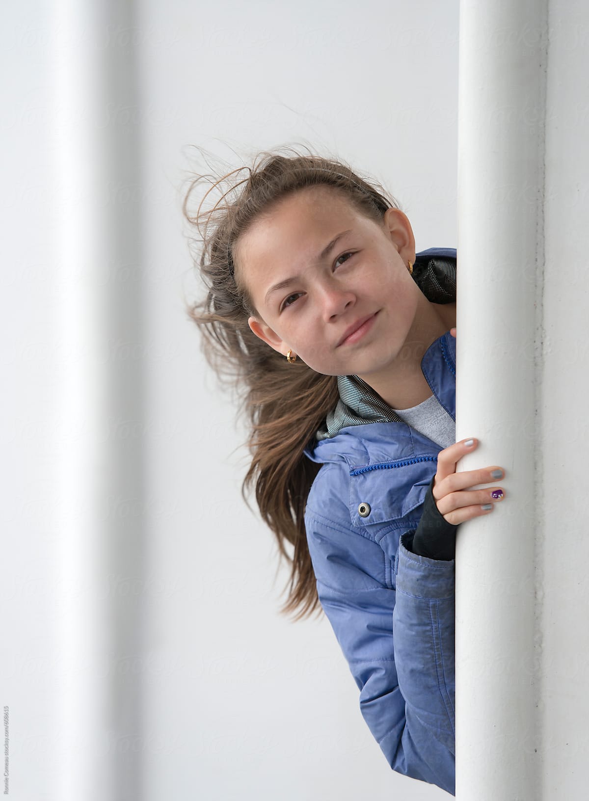 Preteen Girl Peeking From Behind A Wall Del Colaborador De Stocksy Ronnie Comeau Stocksy 