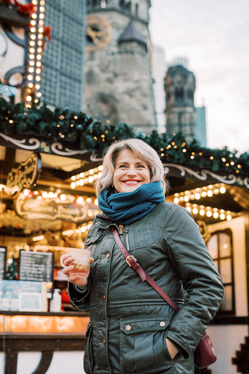Middle-Aged Woman with Hot Wine at Christmas Market smiling