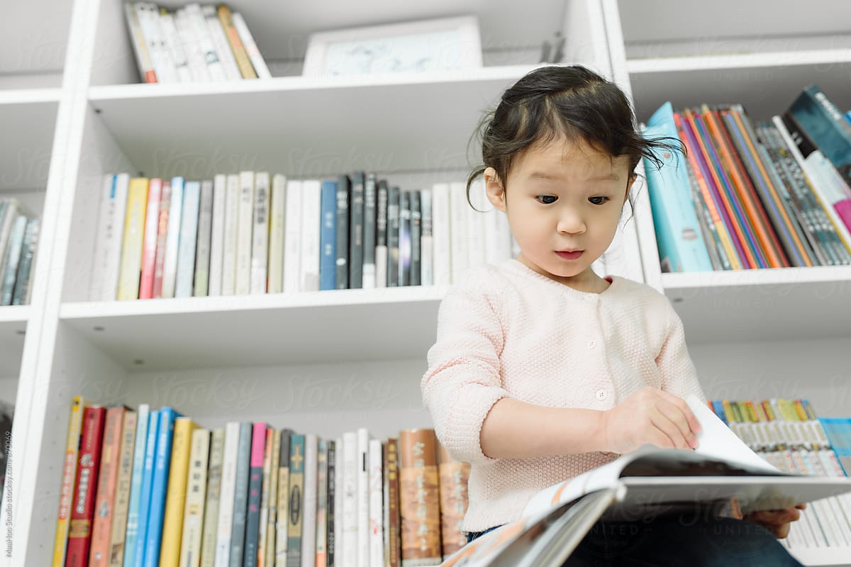 Little girl reading books