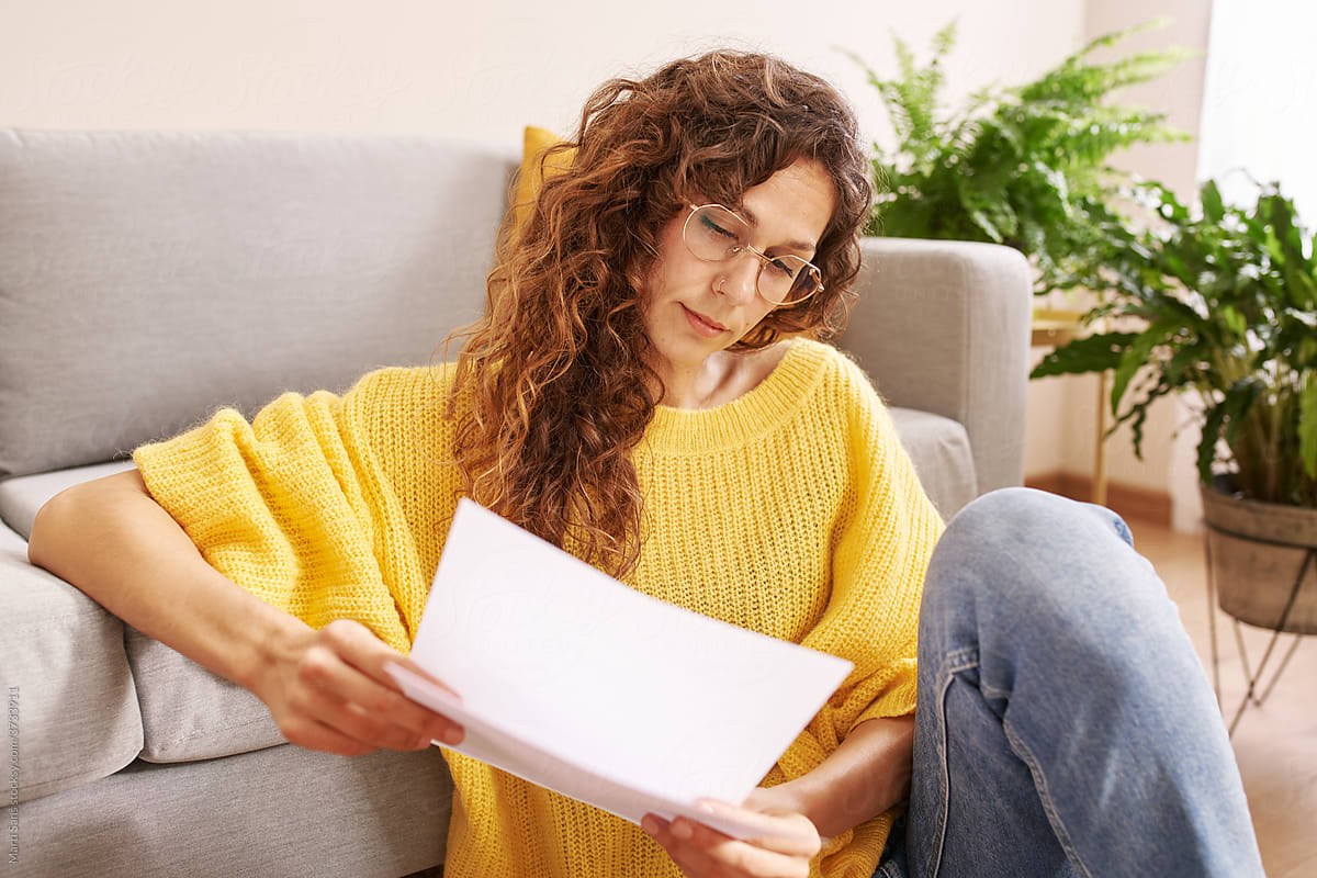Woman reading documents during remote work at home