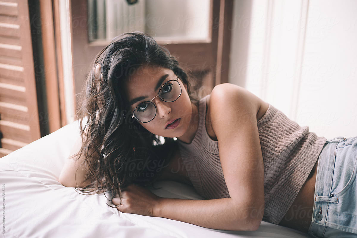 Young Woman With Glasses On A Bed By Stocksy Contributor Lucas Ottone Stocksy