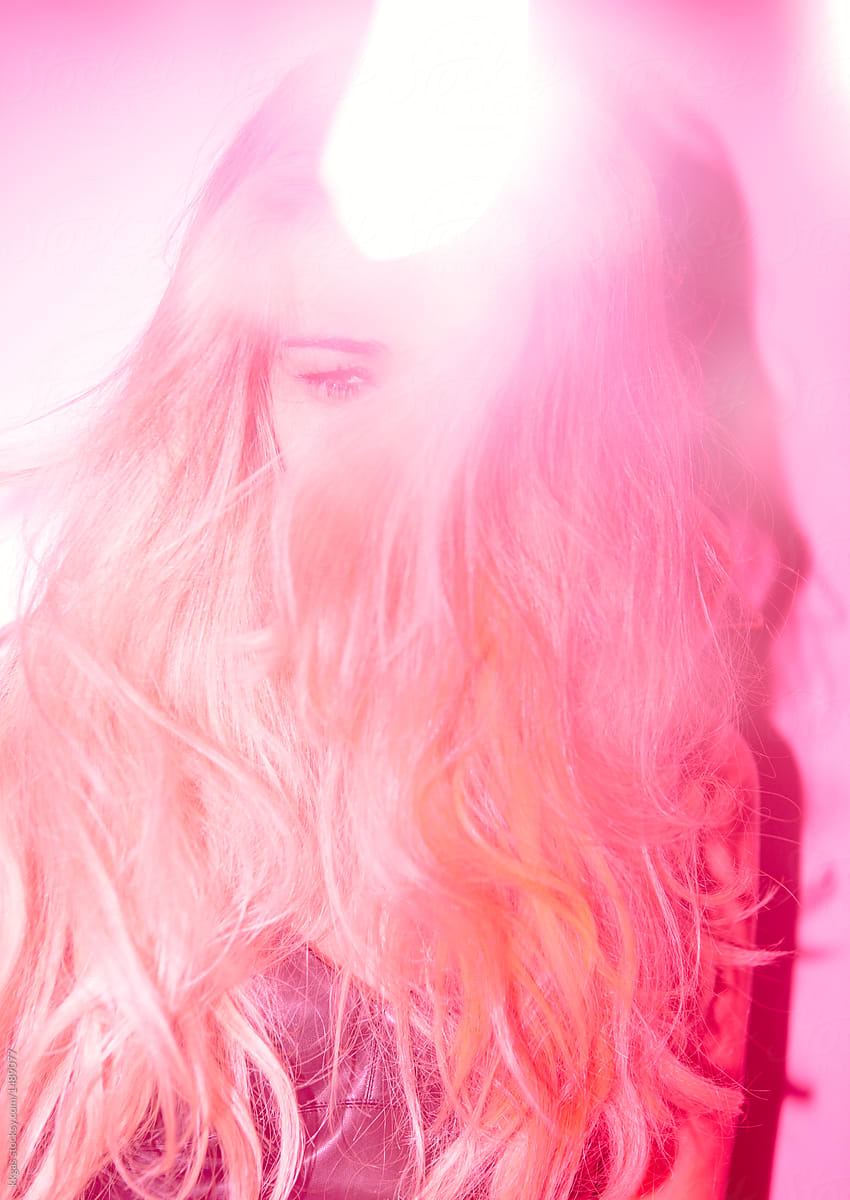 Beautiful Woman With Long Blonde Hair Photographed With Pink Lighting