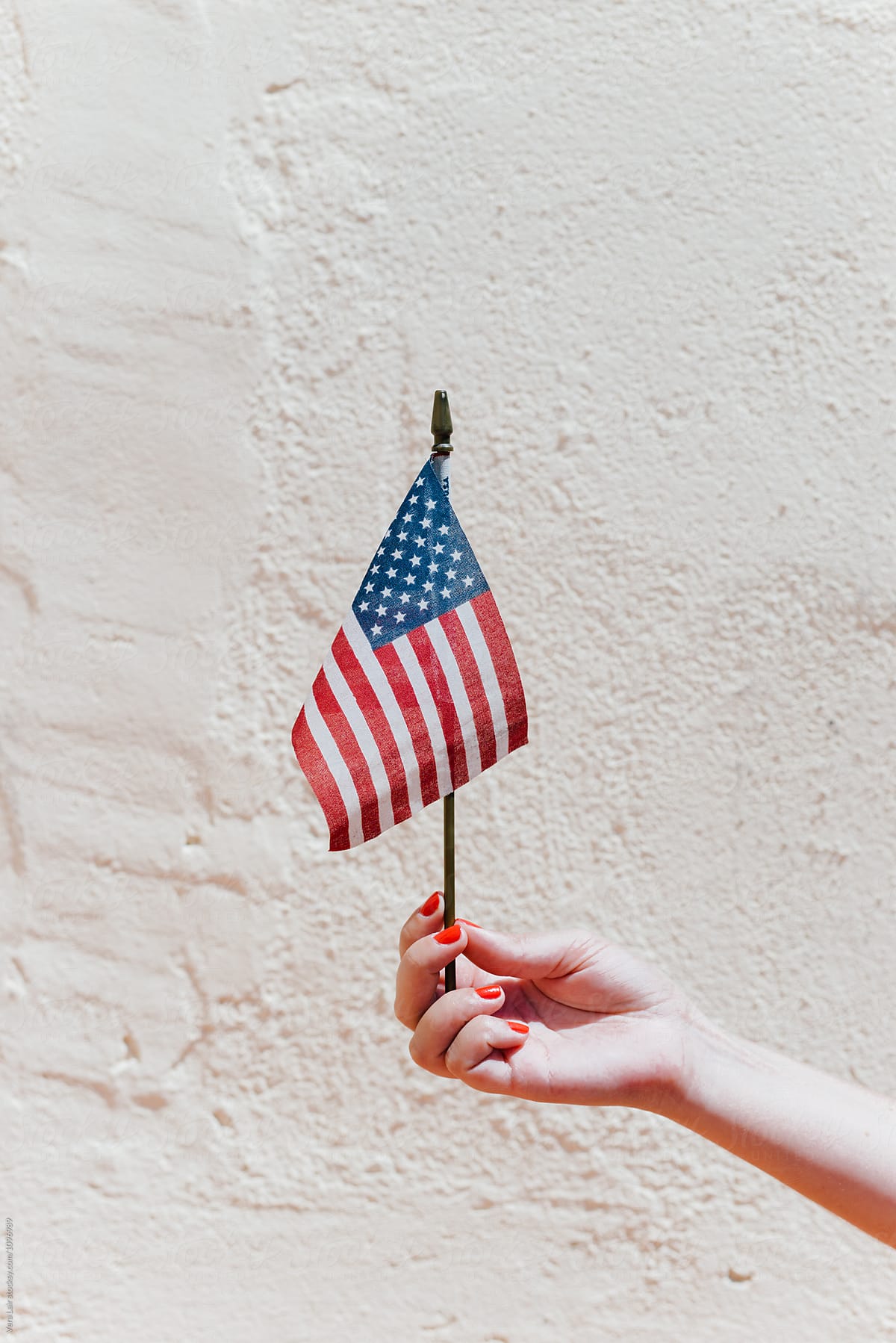 Woman hand holding a small american flag