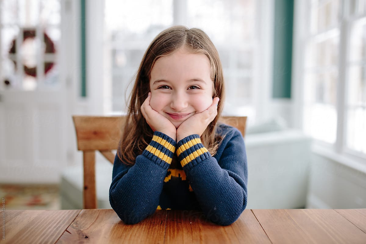 Cute Young Girl Smiling At Table By Stocksy Contributor Jakob Lagerstedt Stocksy