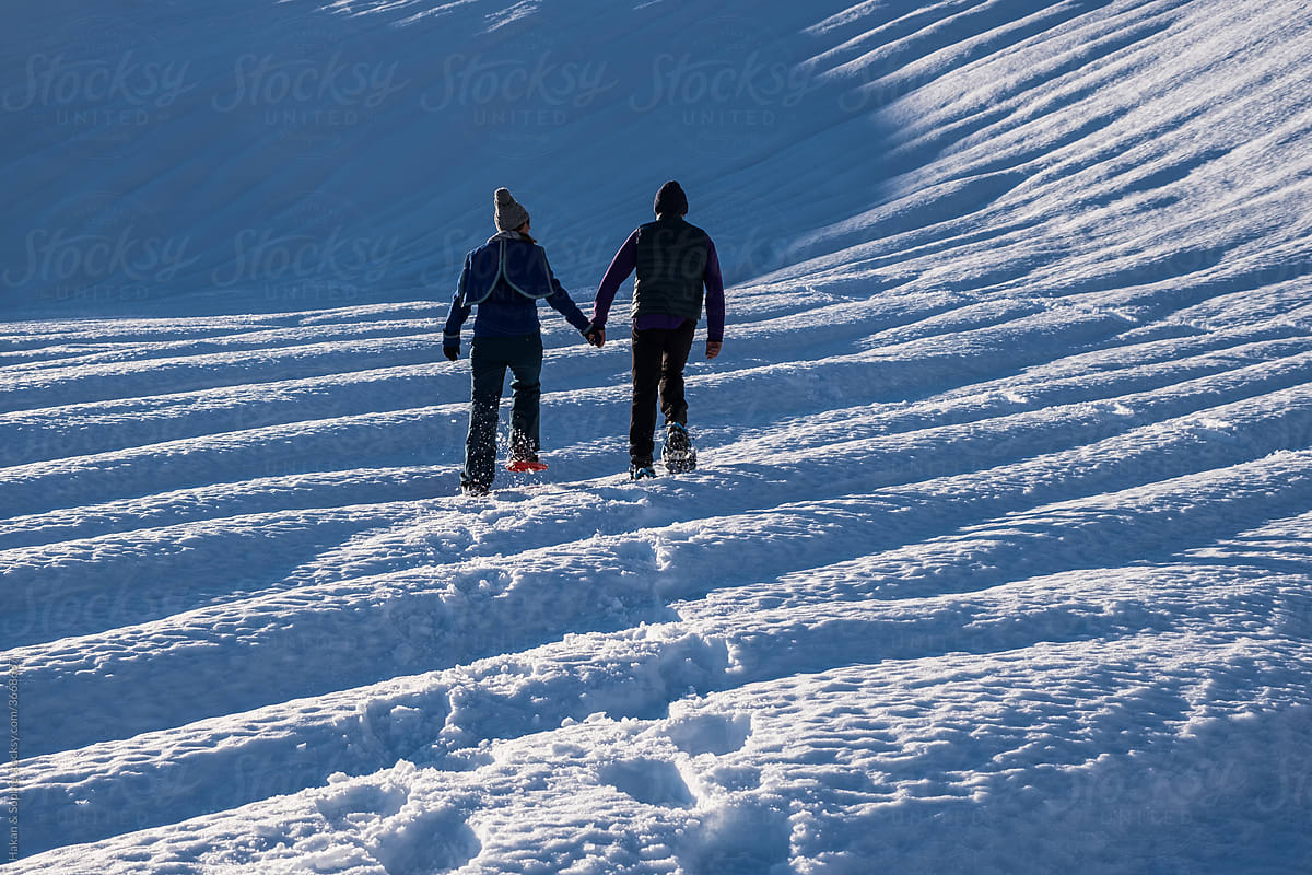 couple walking snowshoes