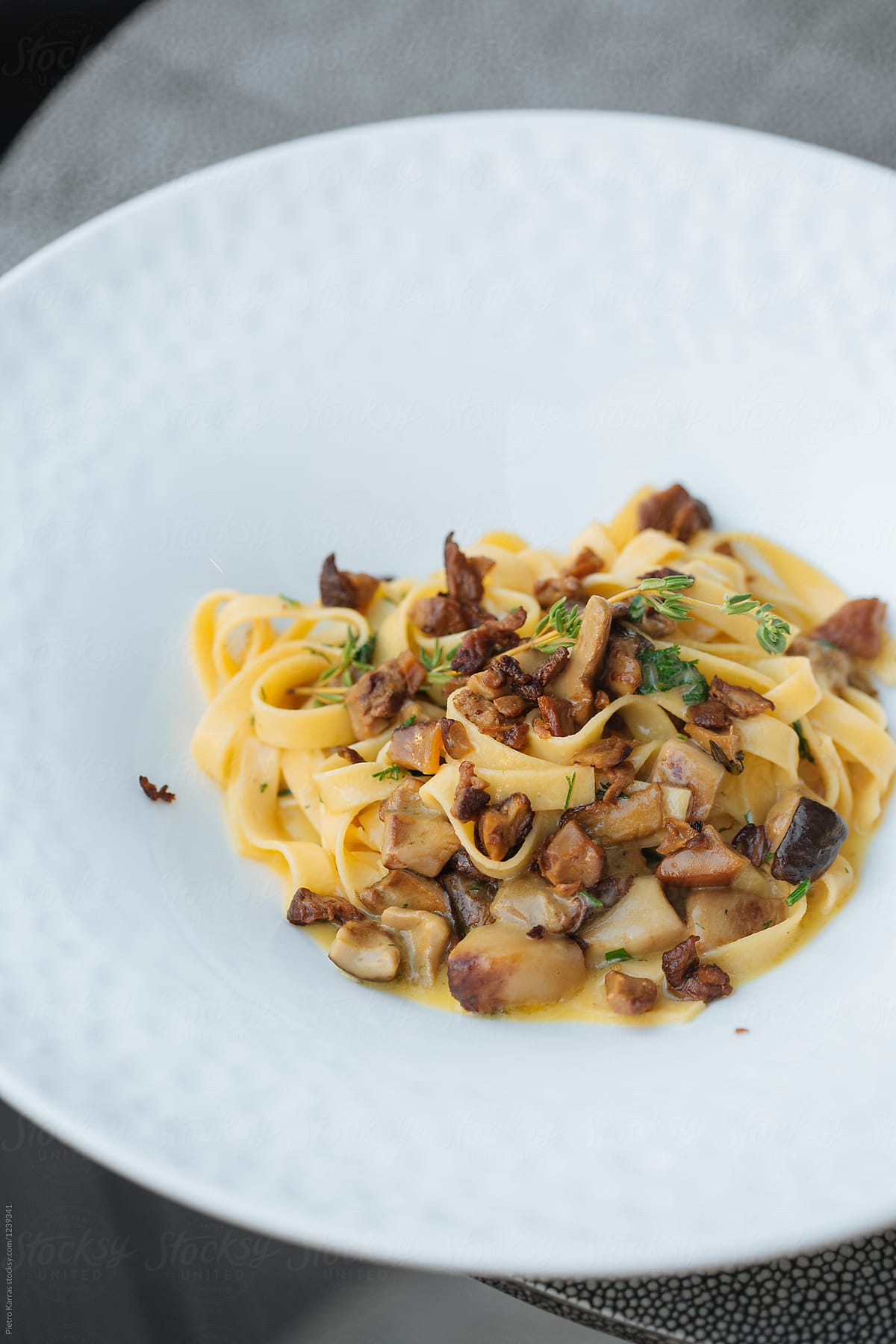 Plate of egg tagliatelle with diced wild mushrooms