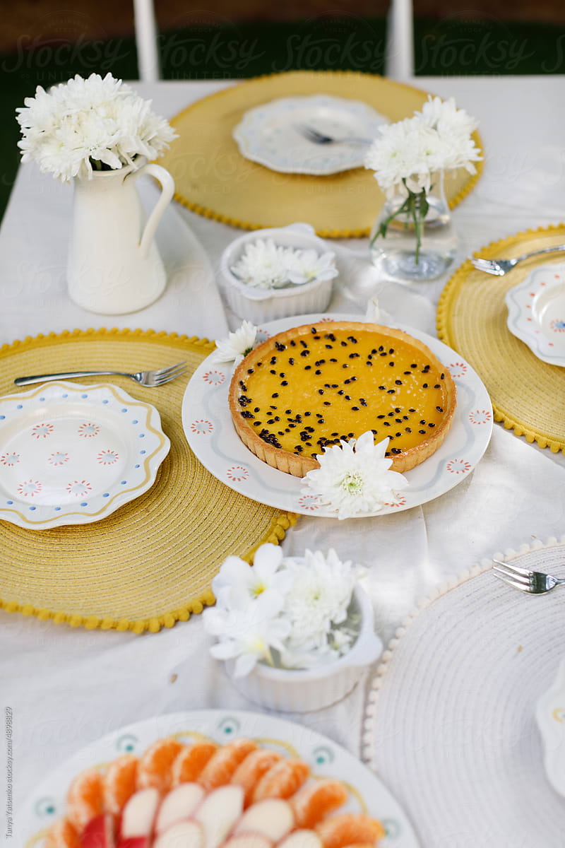 A table served with a tart and fruits