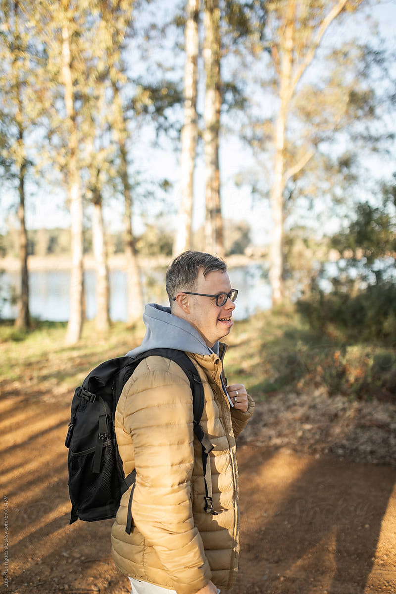 young man with down syndrome walking in nature