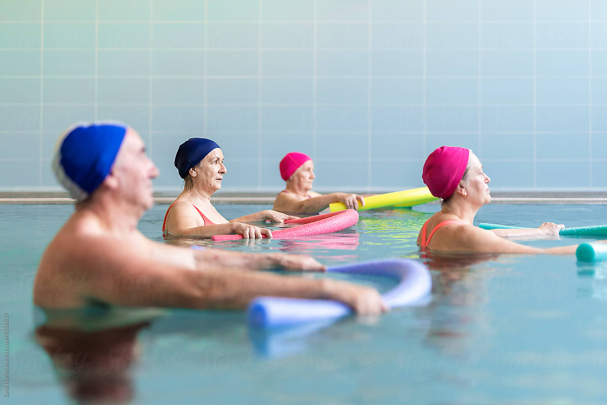 Senior people exercising in pool