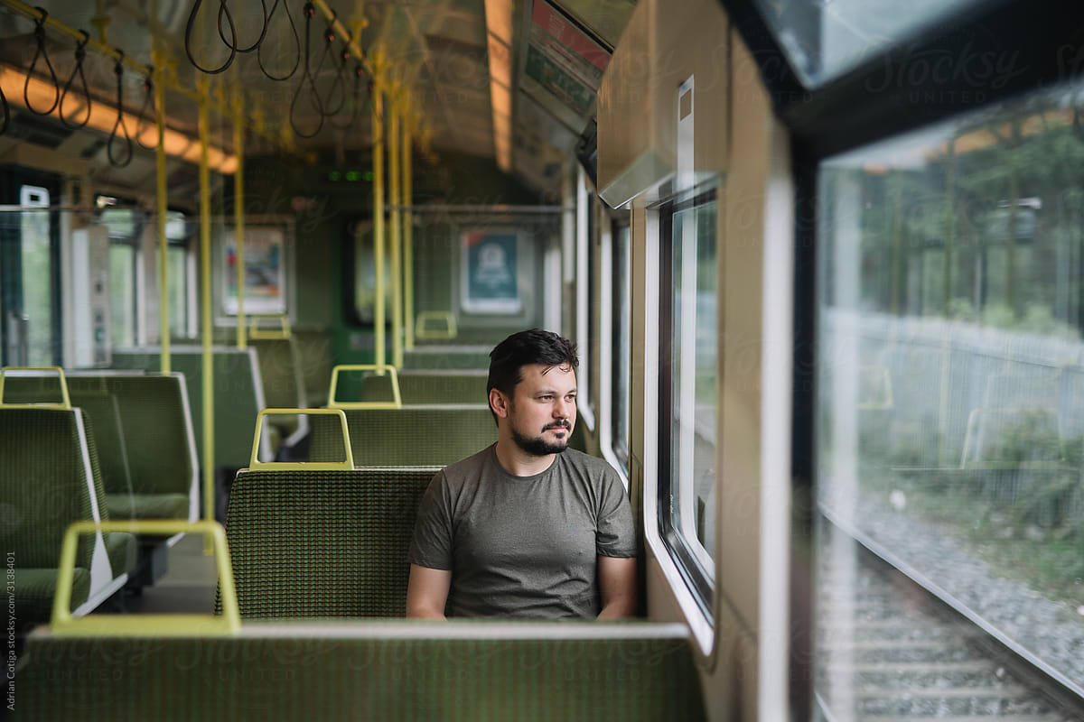 Man Sitting On The Empty Train, Looking Out The Window