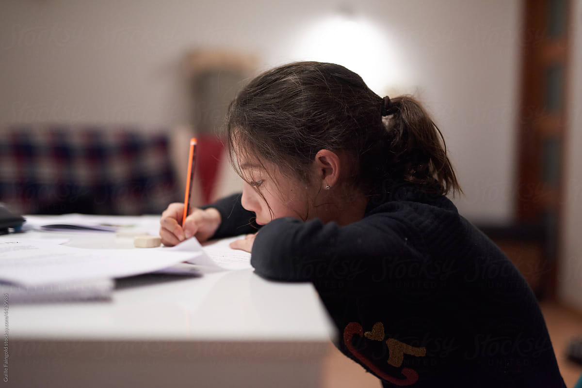 Little girl doing her school homework at home