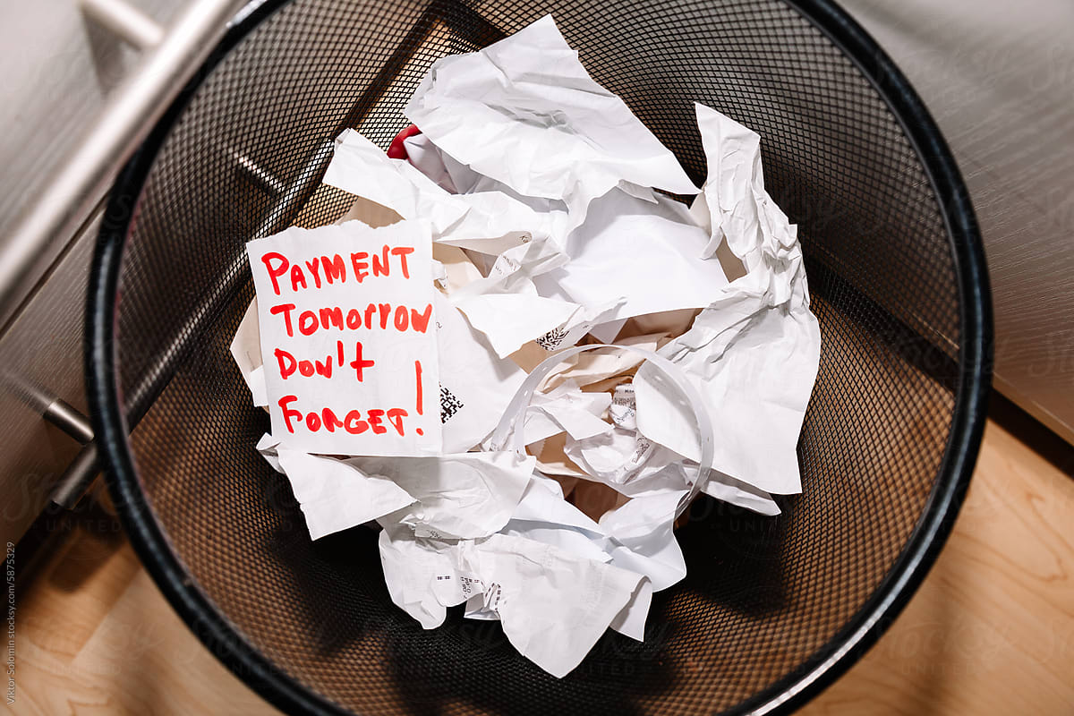 basket full of paper financial papers and receipts on floor in office