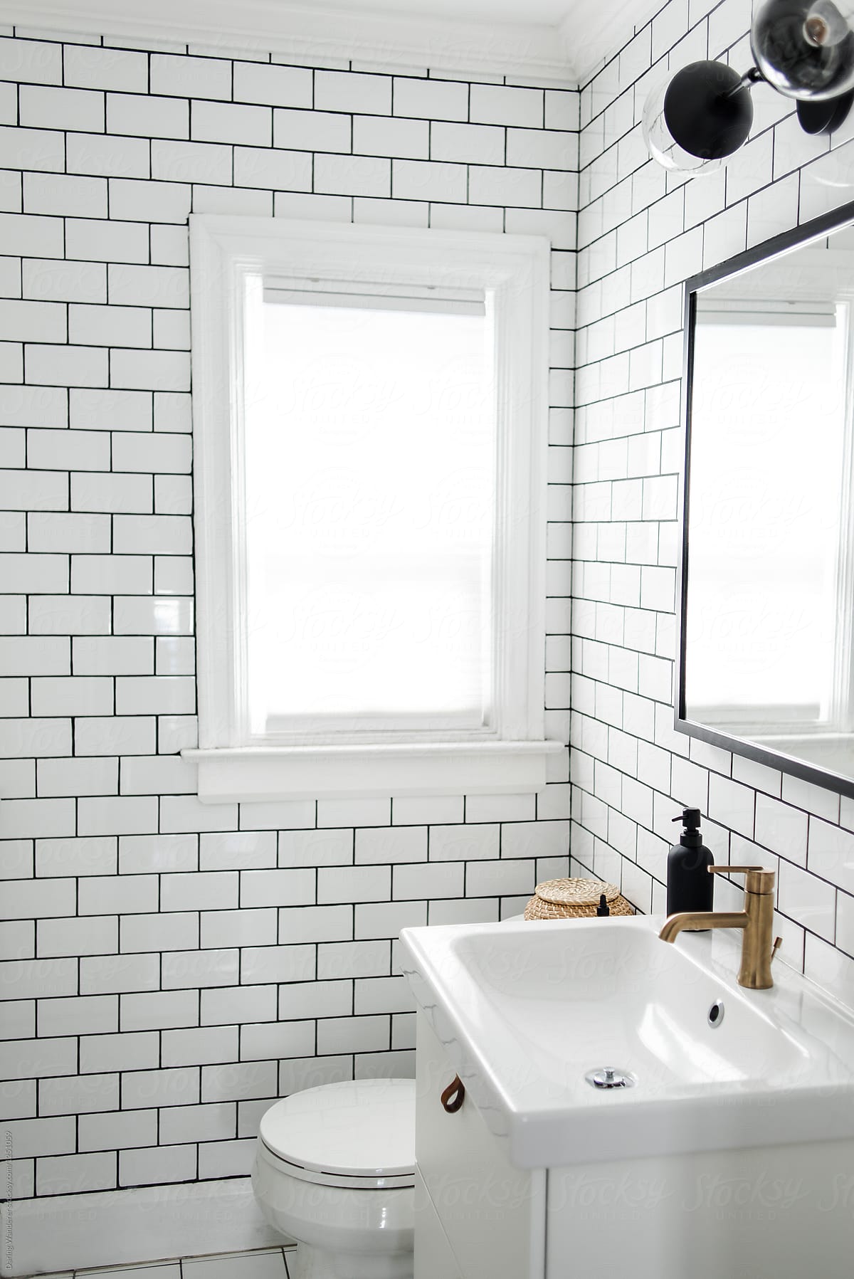 Minimalist Small Bathroom Renovation With White Subway Tile And IKEA Stocksy United