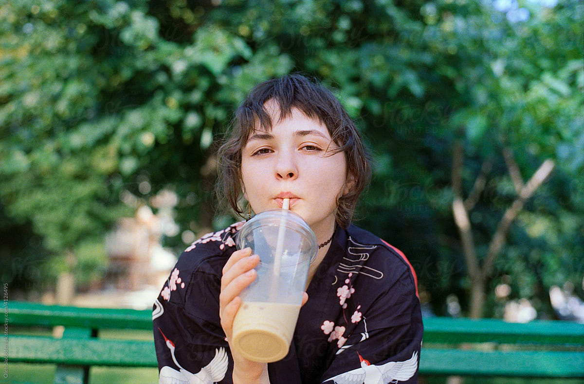 Portrait of woman drinking ice latte