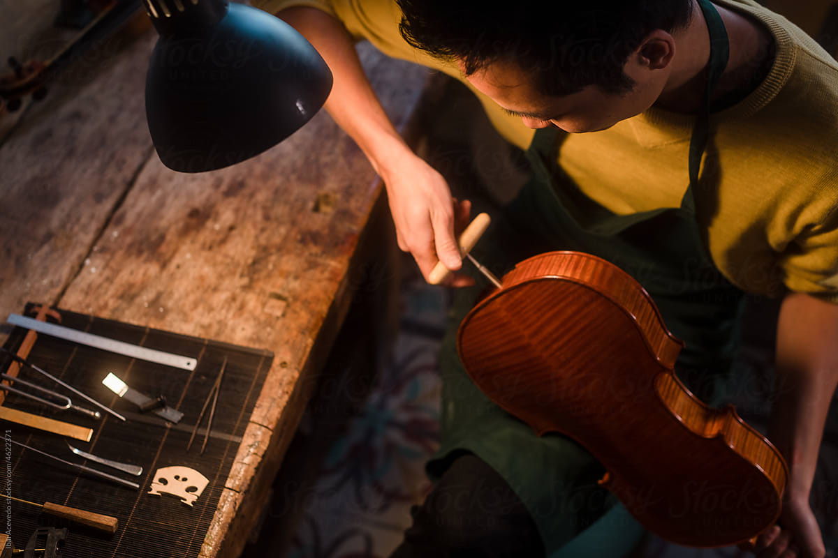 Anonymous violin luthier working at studio