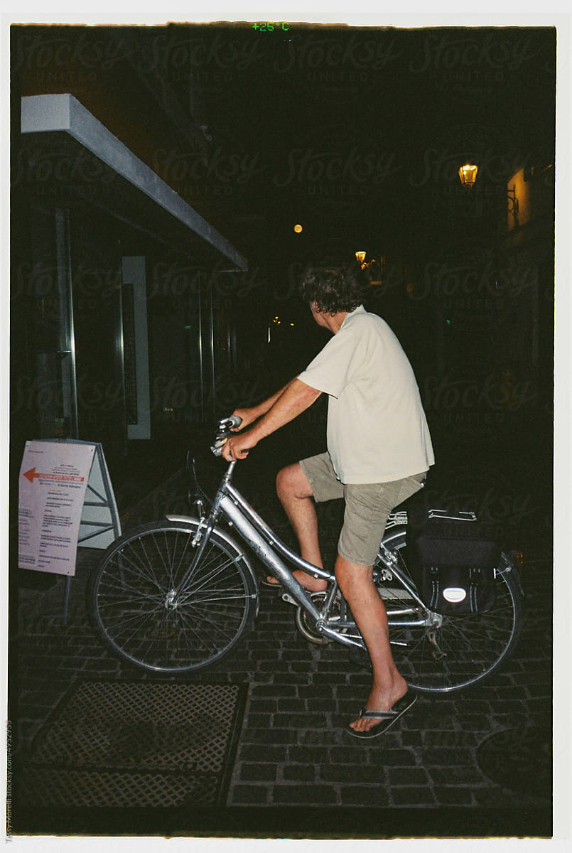 Senior man riding bike at night flash