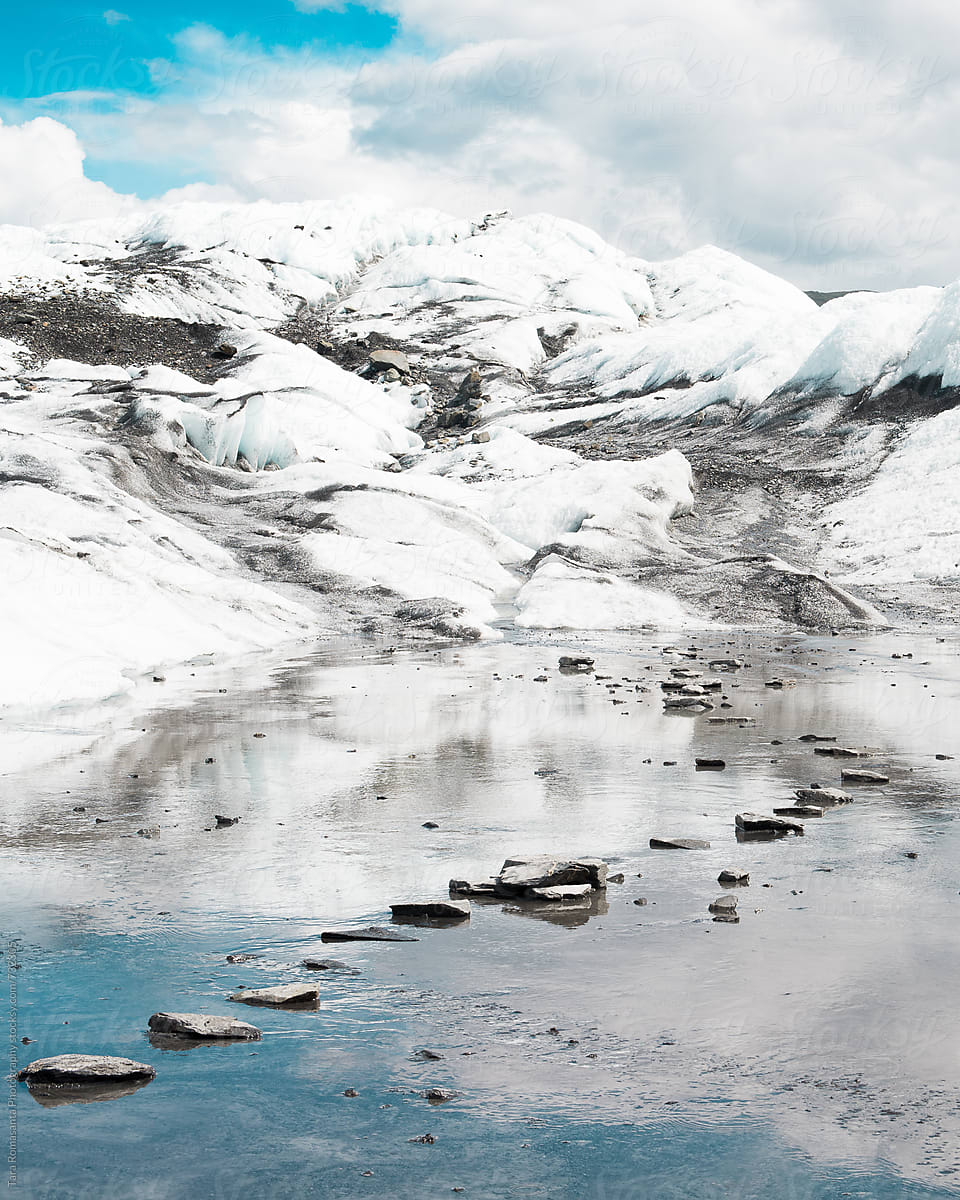 path of stepping stones leading through an icy puddle at Matanuska Glacier in Alaska