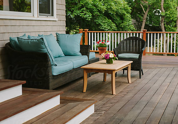Golden Wood Stain Brush Applied By Hand On Mahogany Deck by Stocksy  Contributor Raymond Forbes LLC - Stocksy