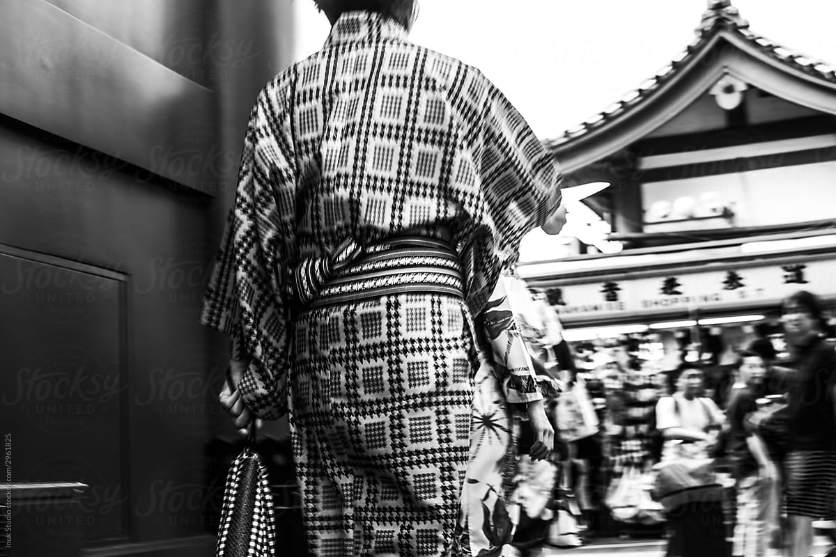 Unrecognizable person in traditional Japanese clothes on street