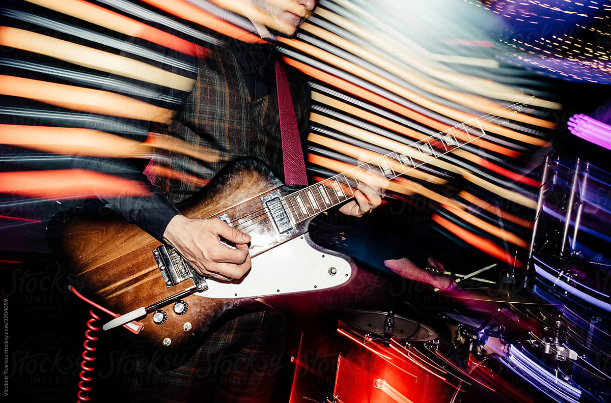 musician plays an electric guitar at a party