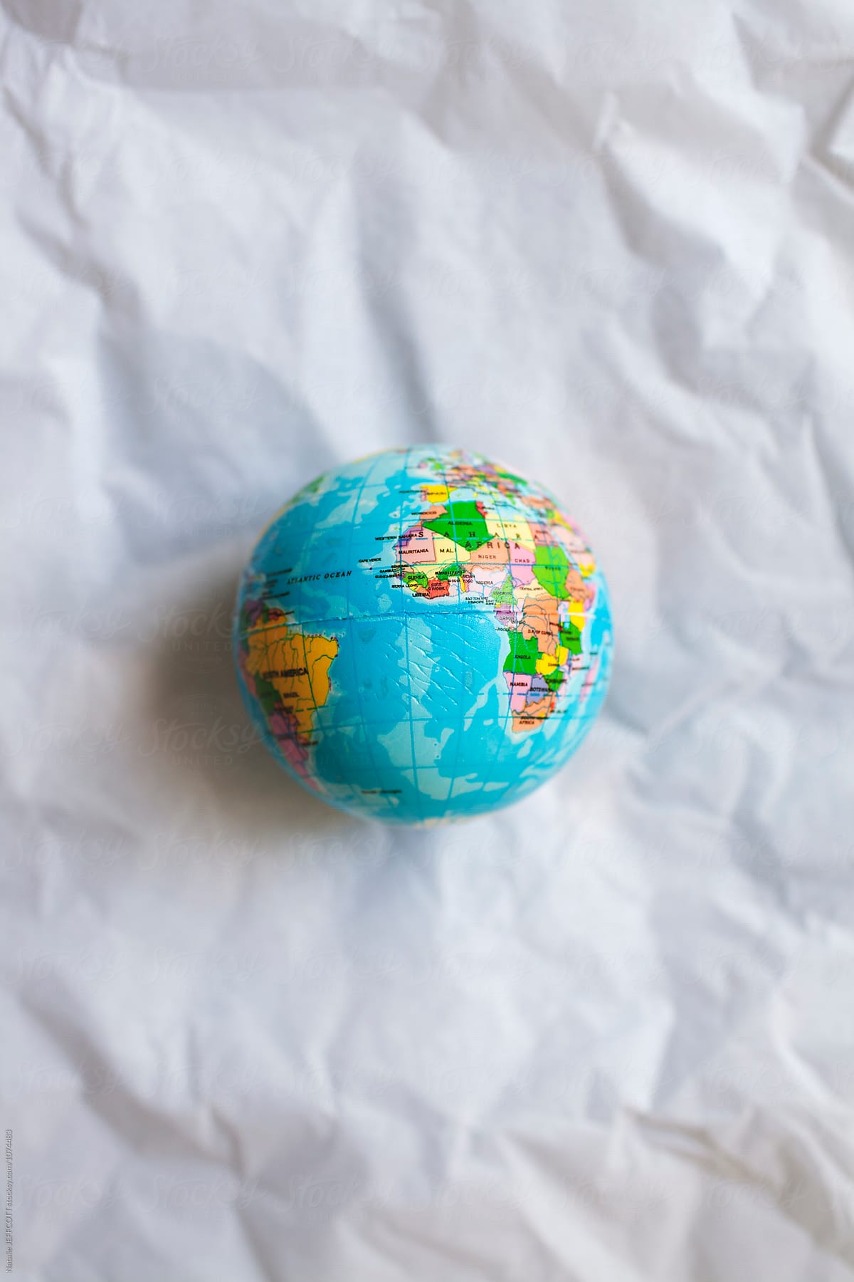 A small world globe on white tissue paper