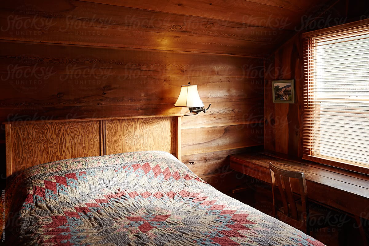 Bed and bedroom in rustic log cabin home