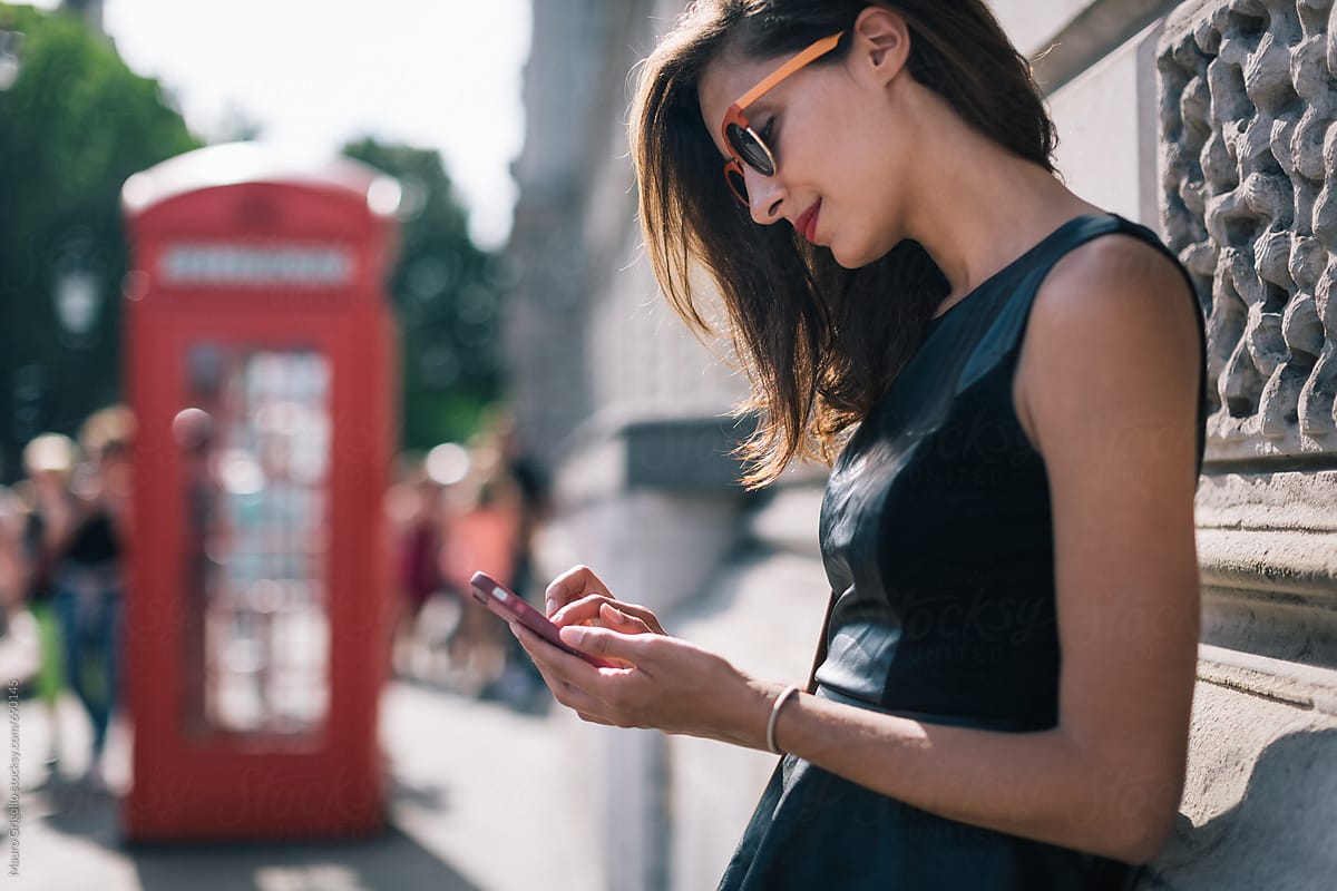 Girl uses a mobile phone in London