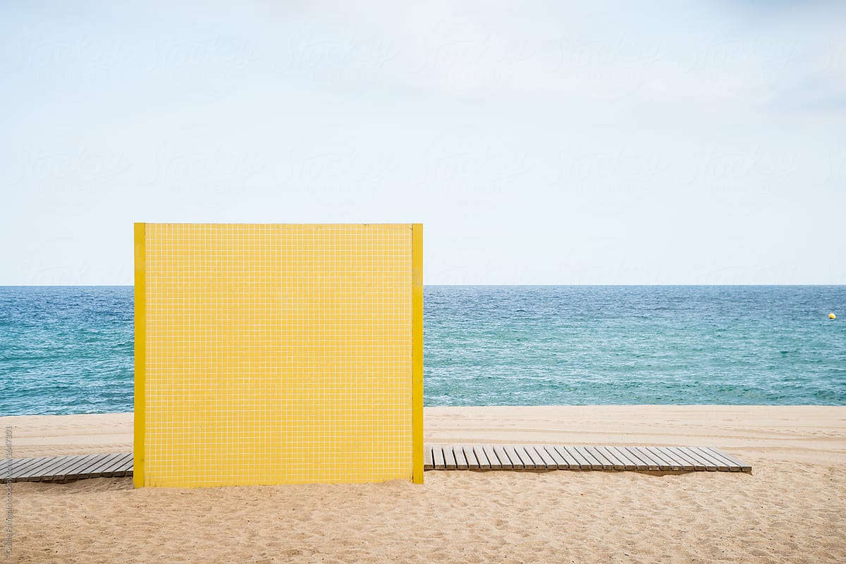 Yellow shower wall on beach