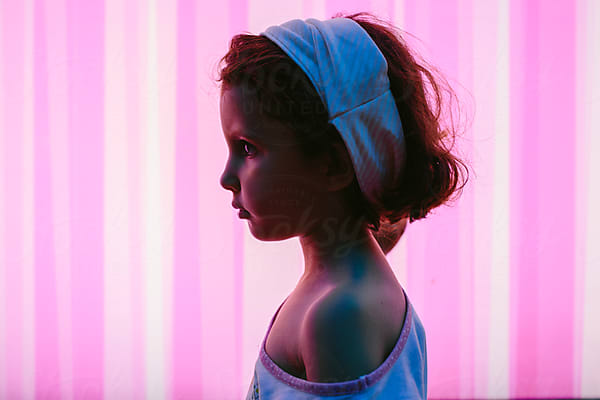 Portrait Of A Little Girl Silhouette Over Pink Neon Lightened