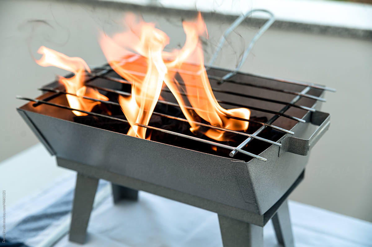 portable bbq grill placed on terrace table of house