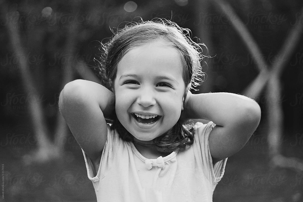 Portrait Of A Cute Young Girl Laughing By Stocksy Contributor Jakob