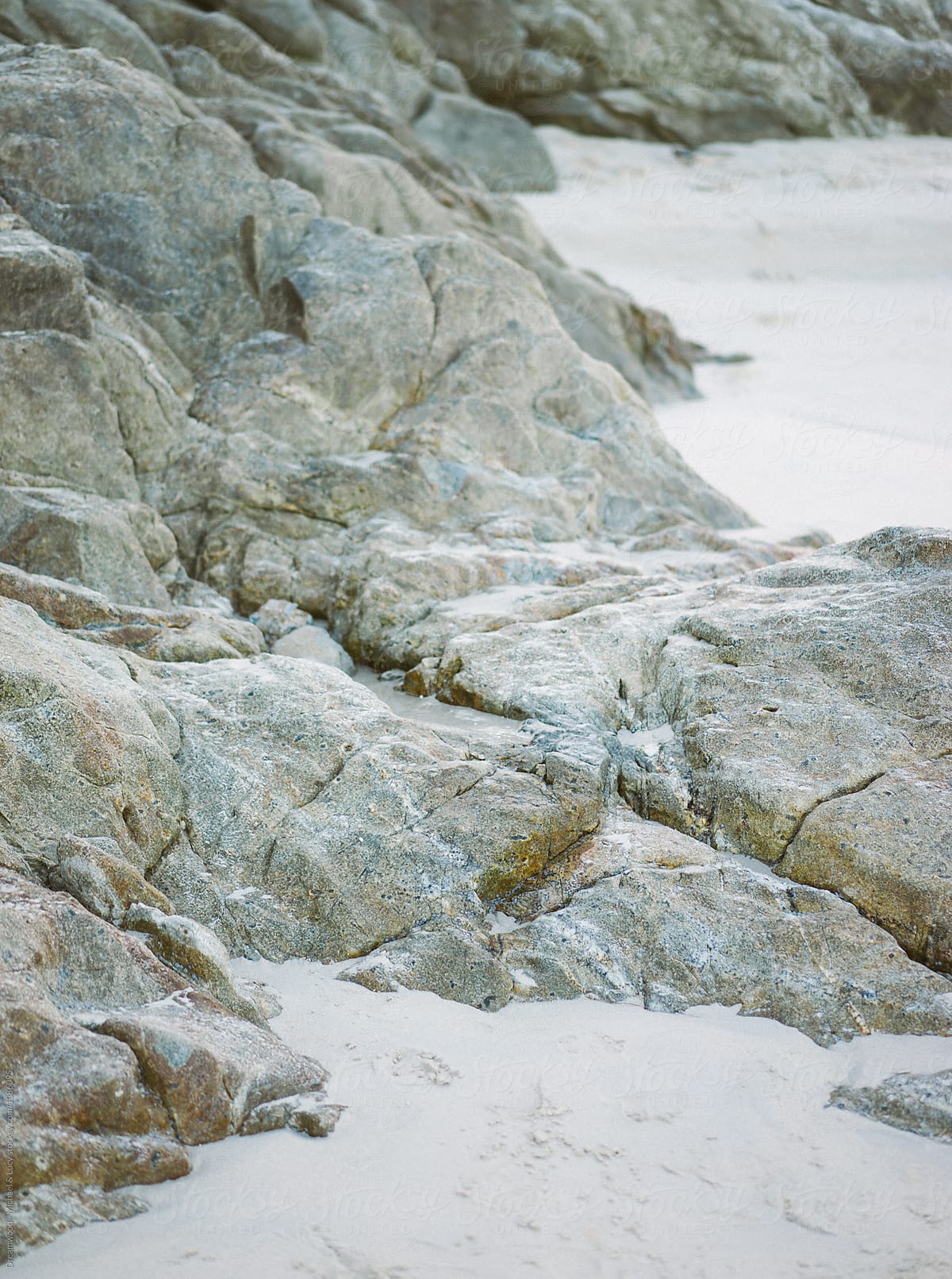 Textured stones lying on beach