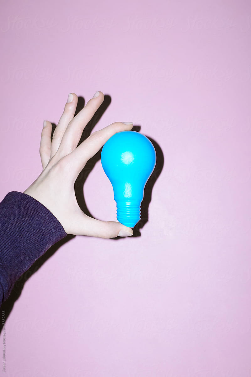Hand holding  light bulb representing new idea, ideation, eureka