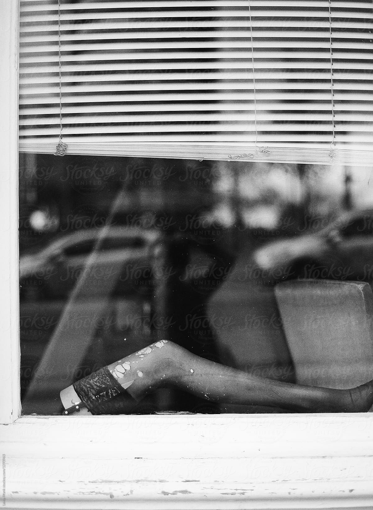 mannequin leg with torn stocking in window