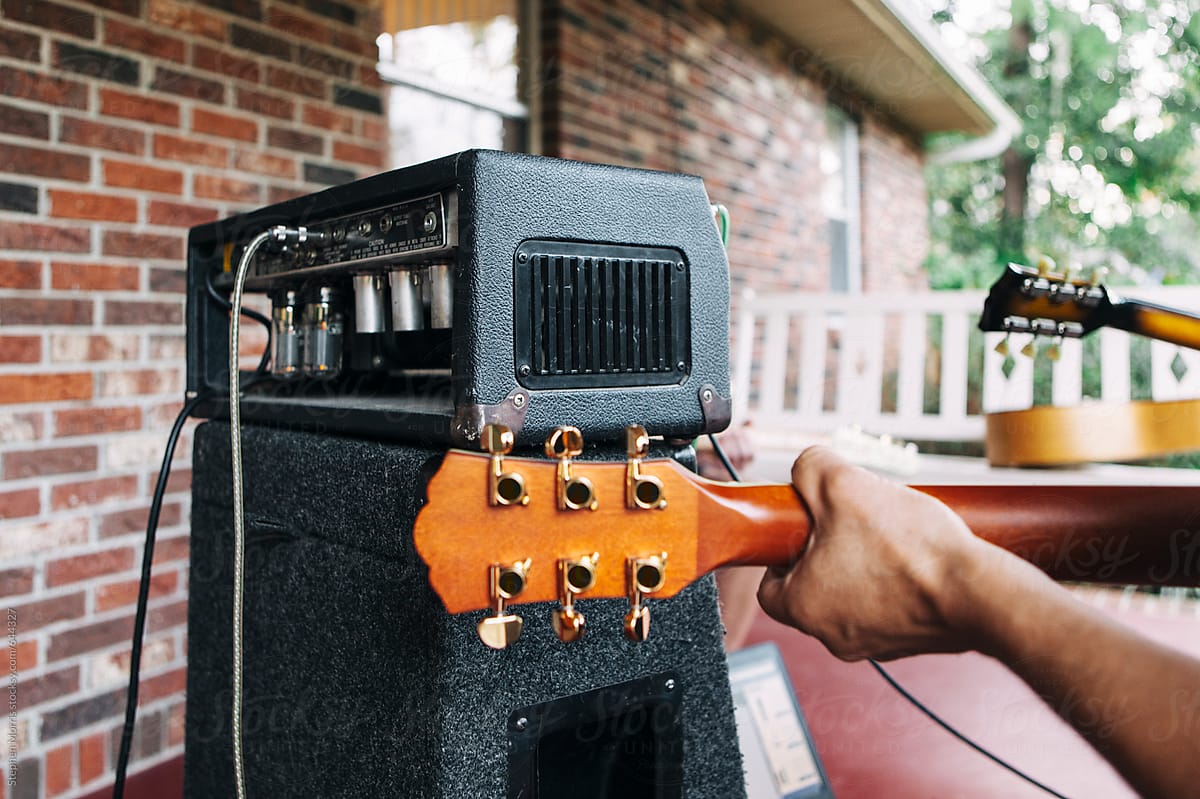 Vintage amplifier with hand playing guitar