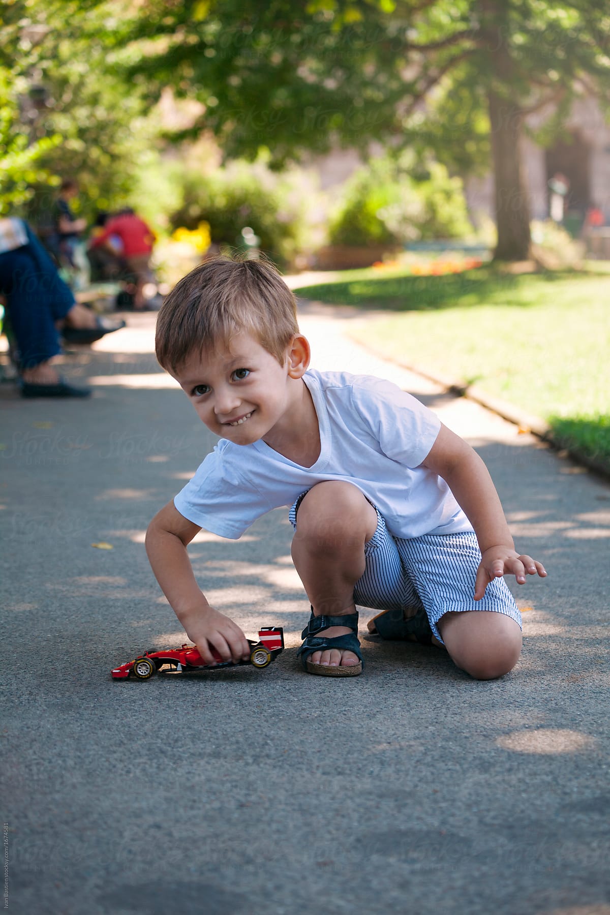 Cute Little Boy Playing With A Car Toy In A Park In Paris -3146