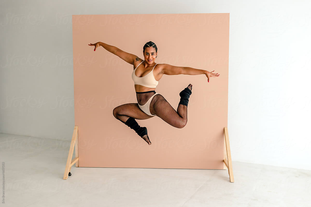 Dancer In Thong Over Fishnets Leaping In Studio by Stocksy Contributor Erin  Brant - Stocksy