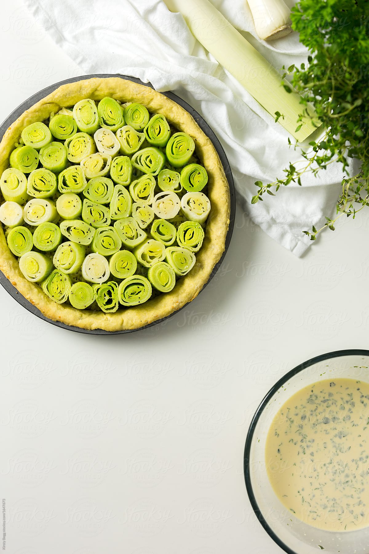 Stage in preparing a leek and cheese tart
