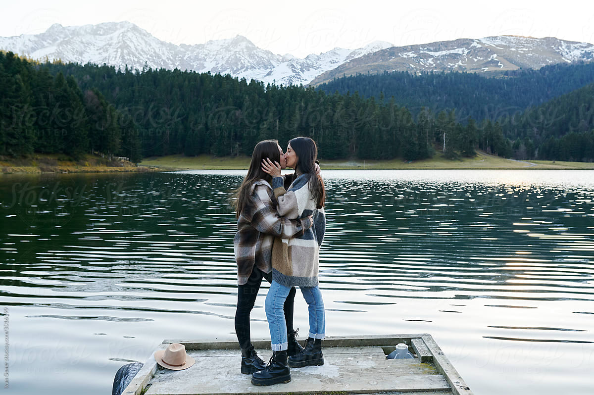 Young Lesbian Couple Sharing A Kiss By A Lake By Stocksy Contributor