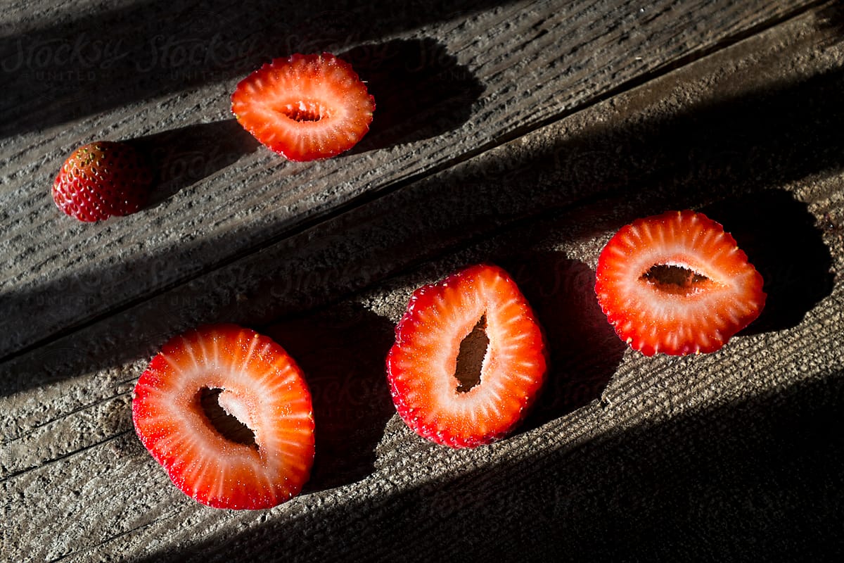 Organic Strawberries Sliced on Wood