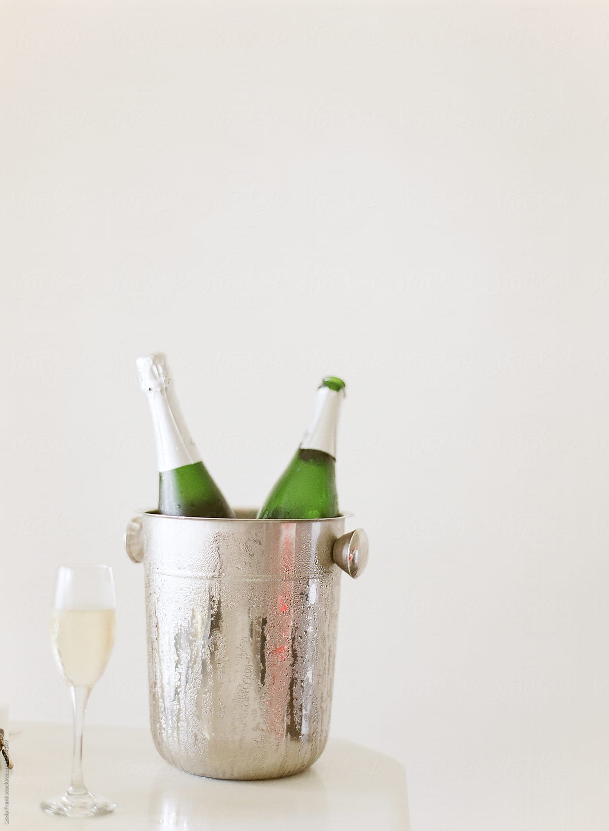 champagne bottles chilling with white background and negative space