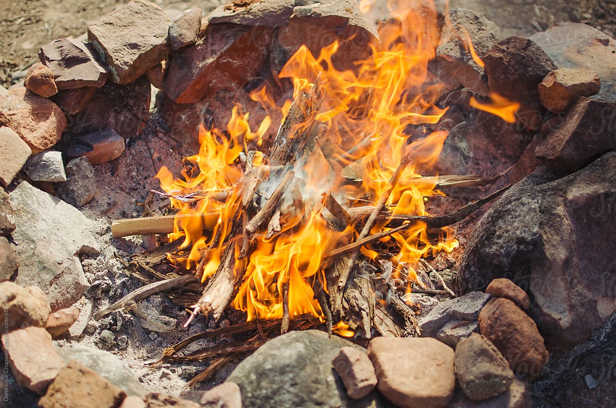 Medium sized campfire with rocks around it