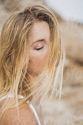 Beautiful Blonde Woman In Underwear By The Rocks by Stocksy