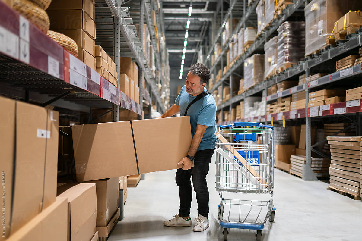 Man Taking Package From The Shelf In Spacious Store